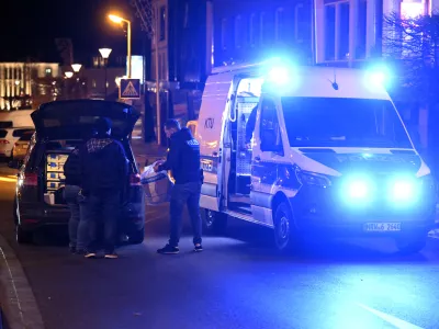 21 December 2025, North Rhine-Westphalia, Geilenkirchen: Police officers stand at the scene in the city center of Geilenkirchen, where shots were fired. A man was shot and injured. Photo: Roberto Pfeil/dpa