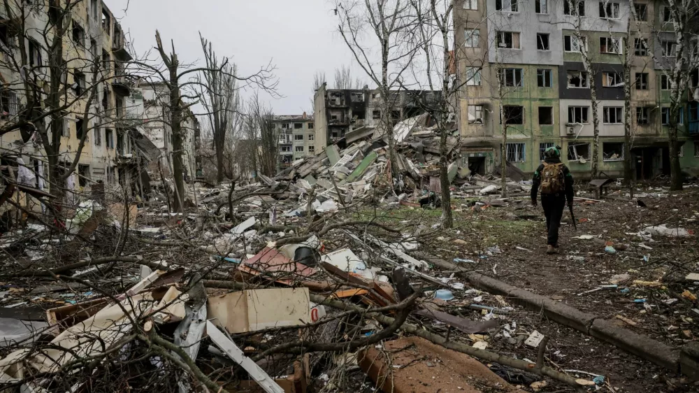 Ukrainian serviceman walks near apartment buildings damaged by Russian military strike, amid Russia's attack on Ukraine, in the frontline town of Kostiantynivka in Donetsk region, Ukraine December 20, 2025. Oleg Petrasiuk/Press Service of the 24th King Danylo Separate Mechanized Brigade of the Ukrainian Armed Forces/Handout via REUTERS ATTENTION EDITORS - THIS IMAGE HAS BEEN SUPPLIED BY A THIRD PARTY.