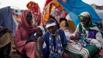 Ikram Abdelhameed looks on next to her family while sitting at a camp for displaced people who fled from al-Fashir to Tawila, North Darfur, Sudan, October 27, 2025. REUTERS/Mohammed Jamal REFILE - CORRECTING ID FROM "GRANDMOTHER OF IKRAM ABDELHAMEED" TO "IKRAM ABDELHAMEED".