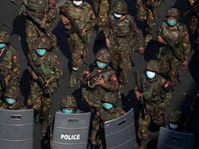 FILE PHOTO: Myanmar soldiers from the 77th light infantry division walk along a street during a protest against the military coup in Yangon, Myanmar, February 28, 2021. Picture taken February 28, 2021. REUTERS/Stringer/File Photo