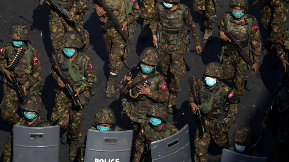 FILE PHOTO: Myanmar soldiers from the 77th light infantry division walk along a street during a protest against the military coup in Yangon, Myanmar, February 28, 2021. Picture taken February 28, 2021. REUTERS/Stringer/File Photo
