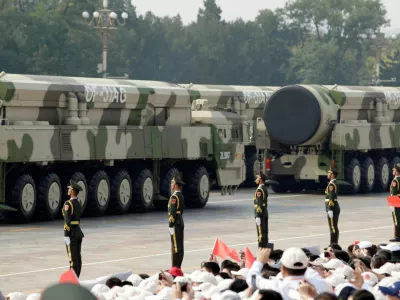 FILE PHOTO: Military vehicles carrying intercontinental ballistic missiles DF-31AG travel past Tiananmen Square during the military parade marking the 70th founding anniversary of People's Republic of China, on its National Day in Beijing, China October 1, 2019./File Photo
