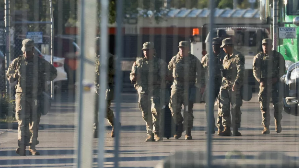 FILE PHOTO: National Guard members walk at the U.S. Immigration and Customs Enforcement (ICE) Broadview facility in Chicago, Illinois, U.S., October 9, 2025. REUTERS/Jeenah Moon/File Photo