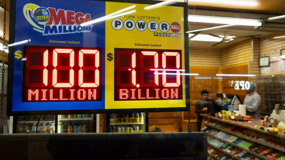 Jackpot payouts for Powerball and Mega Millions are displayed at a convenience store, Tuesday, Dec. 23, 2025, in New York. (AP Photo/Yuki Iwamura)
