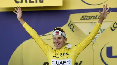 Cycling - Tour de France - Stage 5 - Caen to Caen - Caen, France - July 9, 2025 UAE Team Emirates XRG's Tadej Pogacar celebrates on the podium wearing the yellow jersey after stage 5 REUTERS/Benoit Tessier