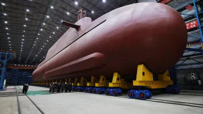 In this undated photo provided Thursday, Dec. 25, 2025, by the North Korean government, its leader Kim Jong Un inspects a nuclear-powered submarine under construction at an undisclosed location in North Korea. Independent journalists were not given access to cover the event depicted in this image distributed by the North Korean government. The content of this image is as provided and cannot be independently verified. Korean language watermark on image as provided by source reads: "KCNA" which is the abbreviation for Korean Central News Agency. (Korean Central News Agency/Korea News Service via AP)