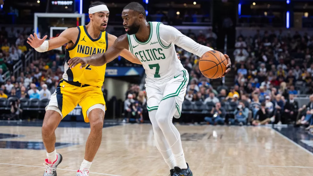 Dec 26, 2025; Indianapolis, Indiana, USA; Boston Celtics guard/forward Jaylen Brown (7) dribbles the ball while Indiana Pacers guard/forward Andrew Nembhard (2) defends in the second half at Gainbridge Fieldhouse. Mandatory Credit: Trevor Ruszkowski-Imagn Images