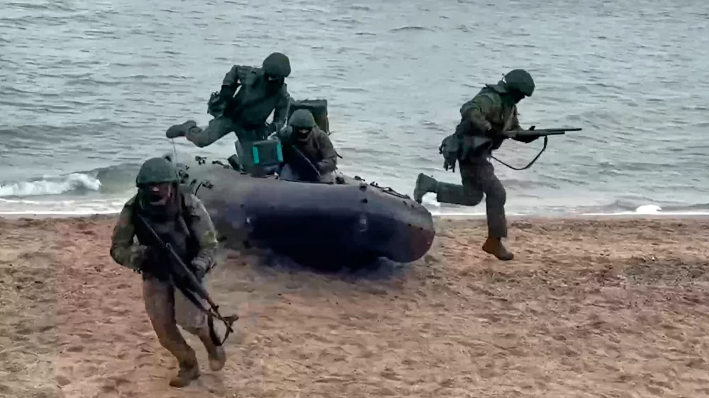In this photo taken from video provided by Russian Defense Ministry Press Service on Thursday, Dec. 25, 2025, Russian soldiers leave a boat to set ensure reliable communications in an undisclosed location in Ukraine. (Russian Defense Ministry Press Service via AP)