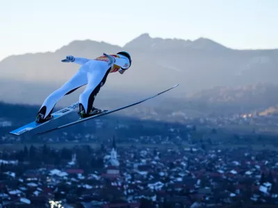 Domen Prevc, of Slovenia, soars through the air during a trial jump at the first stage of the Four Hills ski jumping tournament in Oberstdorf, Germany, Sunday, Dec. 28, 2025. (AP Photo/Matthias Schrader)