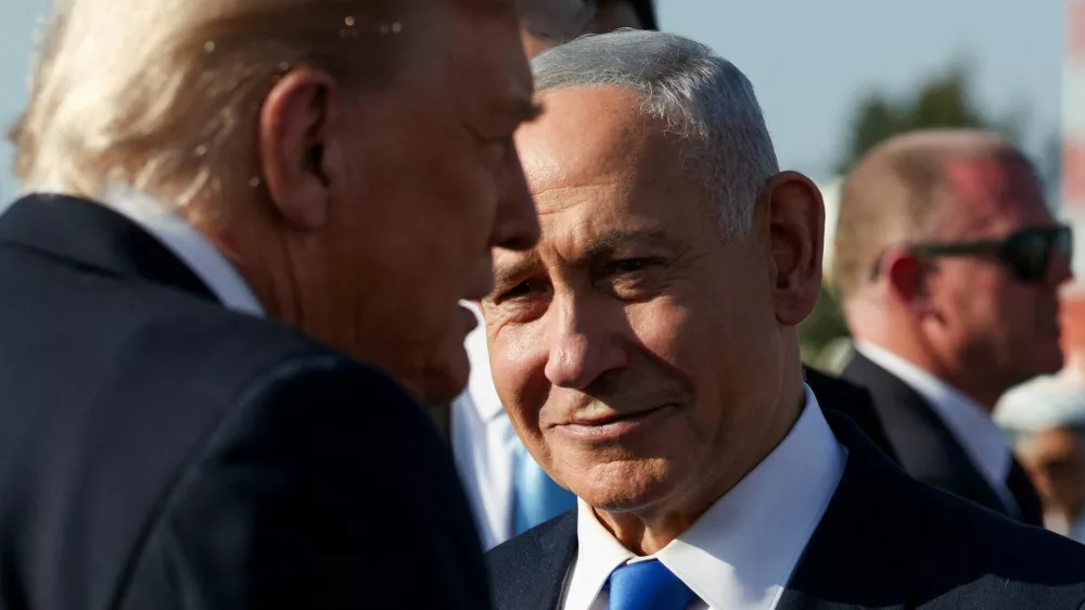 Israeli Prime Minister Benjamin Netanyahu looks on next to U.S. President Donald Trump as Trump leaves Israel en route to Sharm El-Sheikh, Egypt, to attend a world leaders' summit on ending the Gaza war, amid a U.S.-brokered prisoner-hostage swap and ceasefire deal between Israel and Hamas, at Ben Gurion International Airport in Lod, Israel, October 13, 2025. REUTERS/Evelyn Hockstein