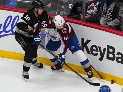 Los Angeles Kings right wing Corey Perry, left, fights for control of the puck with Colorado Avalanche defenseman Samuel Girard in the third period of an NHL hockey game Monday, Dec. 29, 2025, in Denver. (AP Photo/David Zalubowski)