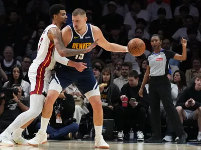 Miami Heat center Kel'El Ware, left, defends Denver Nuggets center Nikola Jokic (15) during the first half of an NBA basketball game, Monday, Dec. 29, 2025, in Miami. (AP Photo/Lynne Sladky)