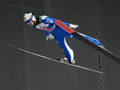 Timi Zajc, of Slovenia, soars through the air during his first round jump at the first stage of the Four Hills ski jumping tournament in Oberstdorf, Germany, Monday, Dec. 29, 2025. (AP Photo/Matthias Schrader)