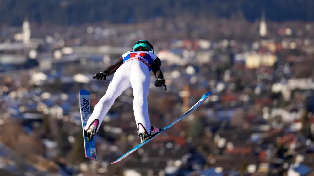 Nika Prevc, of Slovenia, soars through the air during her first round jump at the women's ski jumping World Cup competition in Garmisch-Partenkirchen, Germany, Wednesday, Dec. 31, 2025. (AP Photo/Matthias Schrader)