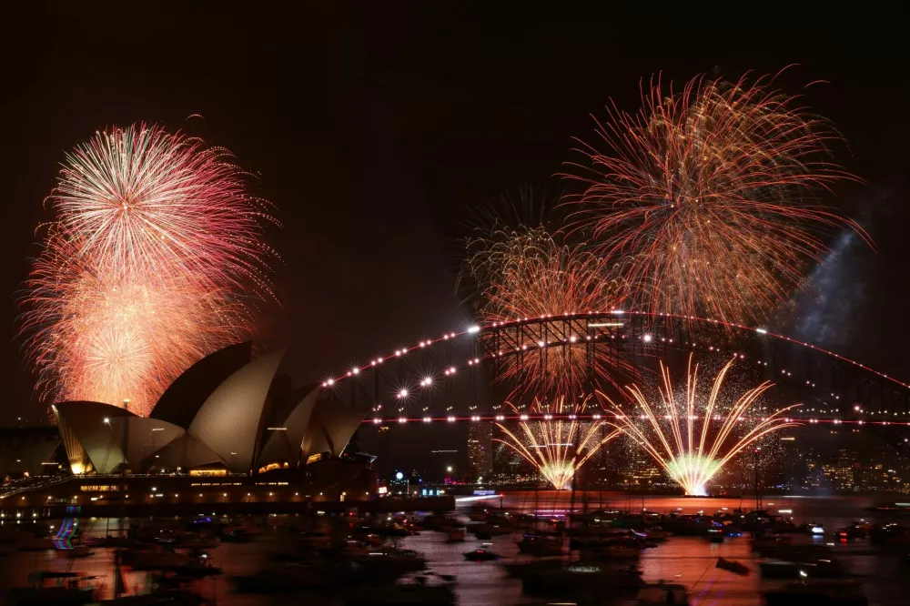 Fireworks explode over Sydney Harbour Bridge at 9 p.m. during New Year's Eve celebrations, in Sydney, Australia, December 31, 2025. REUTERS/Hollie Adams