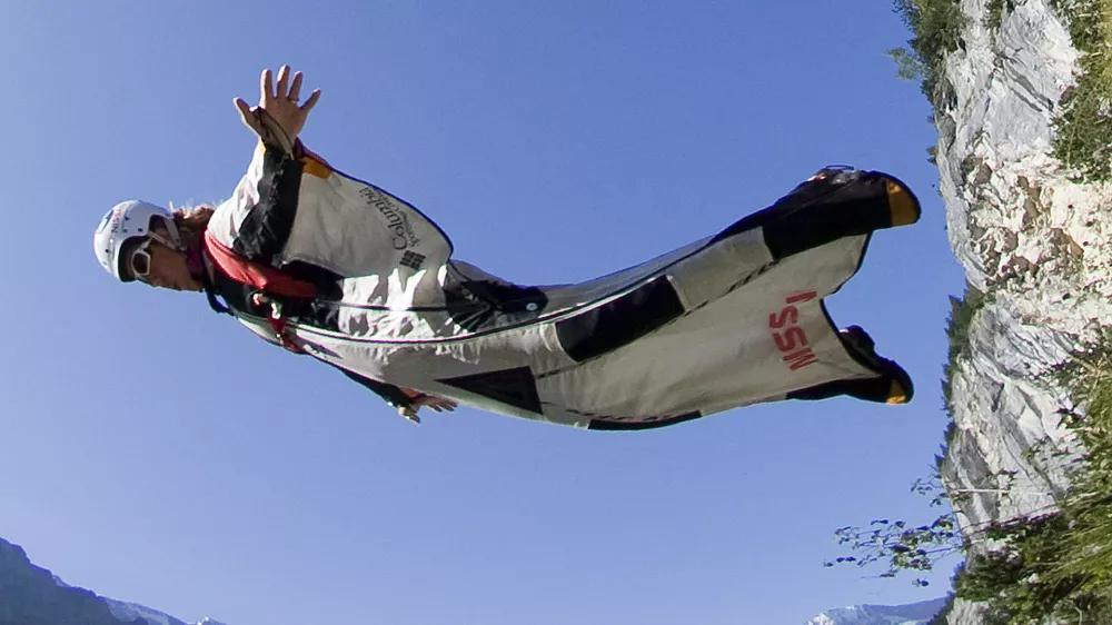 A base jumper leaps from a alpine cliff in the Lauterbrunnen valley in the Bernese Oberland, Switzerland August 13, 2009. Base jumping is the sport of using a parachute to jump a fixed object, either Building, Antenna, Span or Earth. The Lauterbrunnen valley has been used by base jumpers since 1997. Picture taken August 13, 2009. REUTERS/Pascal Lauener (SWITZERLAND SPORT SOCIETY)