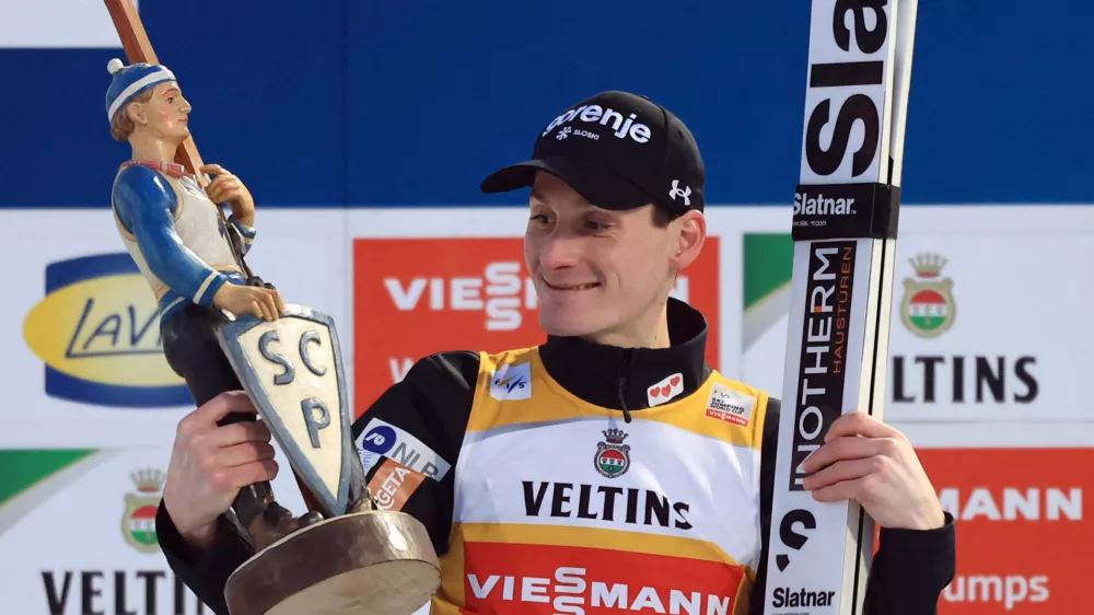 Ski Jumping - Four Hills Tournament - Garmisch-Partenkirchen, Germany - January 1, 2026 Slovenia's Domen Prevc celebrates on the podium with the trophy after winning the Men's Individual HS142 REUTERS/Kai Pfaffenbach