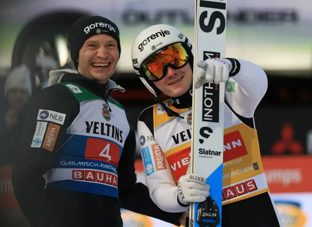 Ski Jumping - Four Hills Tournament - Garmisch-Partenkirchen, Germany - January 1, 2026 Slovenia's Domen Prevc reacts with Slovenia's Anze Lanisek after his final round REUTERS/Kai Pfaffenbach
