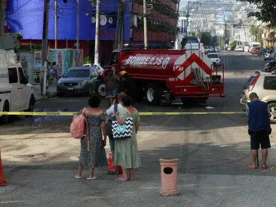 People watch as firefighters work in the area where a transformer fell on an ambulance following an earthquake in Acapulco, Mexico, January 2, 2026. REUTERS/Javier Verdin