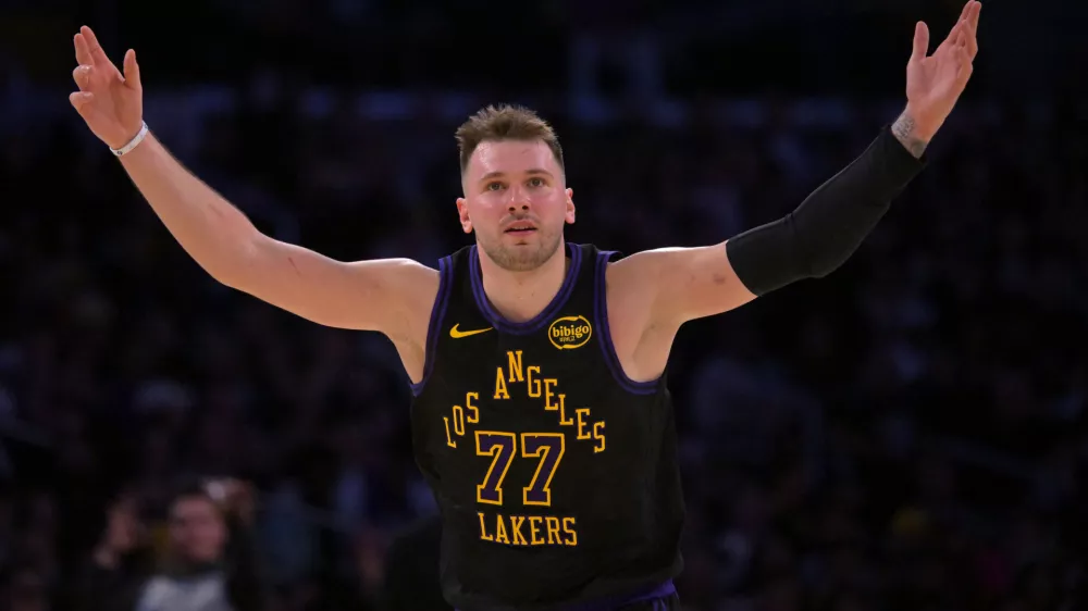 Jan 2, 2026; Los Angeles, California, USA; Los Angeles Lakers guard Luka Doncic (77) reacts after a 3-point basket in the second half against the Memphis Grizzlies at Crypto.com Arena. Mandatory Credit: Jayne Kamin-Oncea-Imagn Images