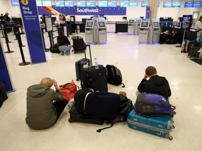 Passengers rest on the floor, after flights were delayed and cancelled when the airspace was closed due to U.S. strikes on Venezuela overnight, at Luis Munoz Marin International Airport in Carolina, near San Juan, Puerto Rico January 3, 2026. REUTERS/Ricardo Arduengo