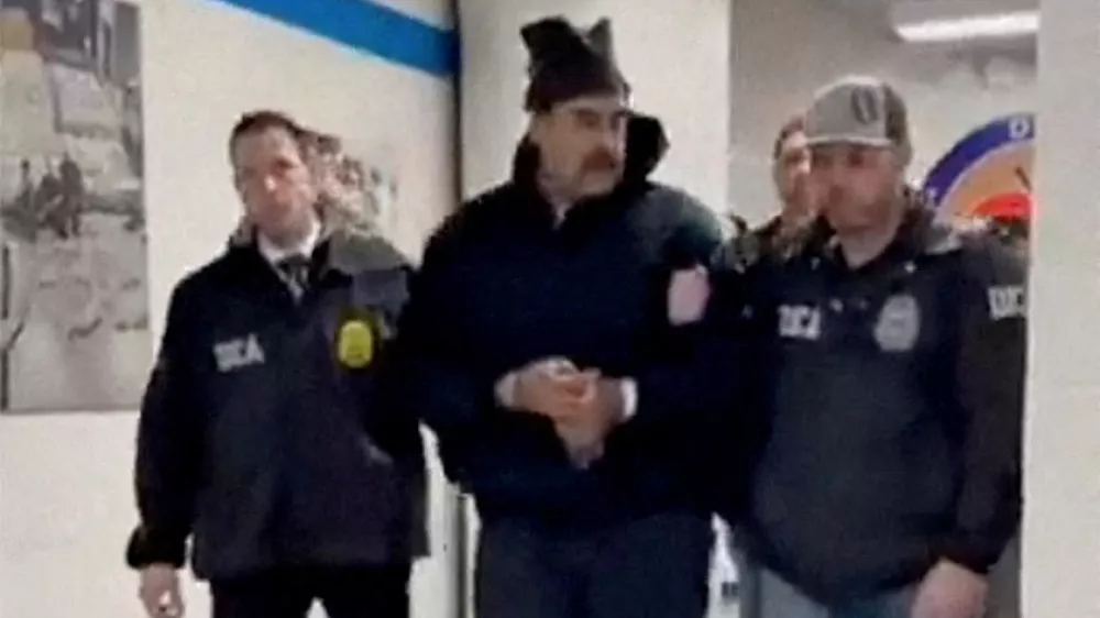 A still image from video posted by the White House's Rapid Response 47 account on X.com, which originated from the @PaulDMauro account, shows Venezuela's President Nicolas Maduro being walked in custody down a hallway at the offices of the U.S. Drug Enforcement Administration (DEA) in New York City, U.S., January 3, 2026. @RapidResponse47/Handout via REUTERS THIS IMAGE HAS BEEN SUPPLIED BY A THIRD PARTY. MANDATORY CREDIT.NO RESALES. NO ARCHIVES. THIS PICTURE WAS PROCESSED BY REUTERS TO ENHANCE QUALITY. AN UNPROCESSED VERSION HAS BEEN PROVIDED SEPARATELY.   TPX IMAGES OF THE DAY    Verification - Reuters was able to confirm footage of Nicolas Maduro walking through the halls of DEA headquarters in New York as seen on corroborating footage showing same personnels ushering Maduro and DEA NYD crest on the wall. - Logo on wall matched DEA NYD from file images. - Reuters witness footage showing convoy arriving at DEA headquarters in Manhattan.