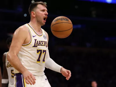 Jan 4, 2026; Los Angeles, California, USA; Los Angeles Lakers guard Luka Doncic (77) reacts to a play during the third quarter against the Memphis Grizzlies at Crypto.com Arena. Mandatory Credit: Kiyoshi Mio-Imagn Images