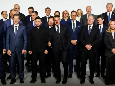 France's President Emmanuel Macron gestures as Poland's Prime Minister Donald Tusk, Slovenia's Prime Minister Robert Golob, Ukraine's President Volodymyr Zelenskiy, Britain's Prime Minister Keir Starmer and Italy's Prime Minister Giorgia Meloni react as they arrive to pose for a family photo on the sideline of the so-called 'Coalition of the Willing' summit, at the Elysee Palace in Paris, France, January 6, 2026. LUDOVIC MARIN/Pool via REUTERS