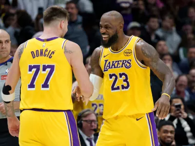 Los Angeles Lakers forward/guard Luka Dončić (77) celebrates a three point basket with forward LeBron James (23) against the New Orleans Pelicans during the second half of an NBA basketball game in New Orleans, Tuesday, Jan. 6, 2026. (AP Photo/Matthew Hinton)