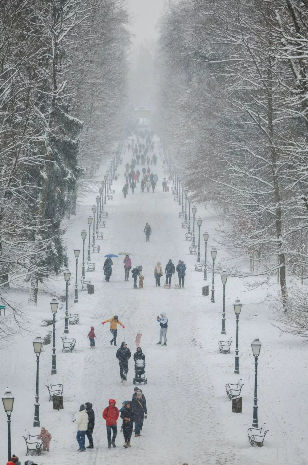 People walk in a snow-covered Maksimir park in Zagreb, Croatia, January 6, 2026. REUTERS/Antonio Bronic