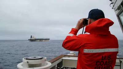 A U.S. Coast Guard official looks through binoculars at the ship Marinera (Ex-Bella 1) in this handout image released January 7, 2026. US EUROPEAN COMMAND via X/Handout via REUTERS  THIS IMAGE HAS BEEN SUPPLIED BY A THIRD PARTY. MANDATORY CREDIT. Verification lines: Reuters was not able to independently verify the location or the date when the photos were taken. But a U.S. official told Reuters the United States had pursued the tanker for more than two weeks across the Atlantic. Searches for the images found they had not appeared online before. The identity of the oil tanker was confirmed by the structures on the deck and bridge which matched file imagery.