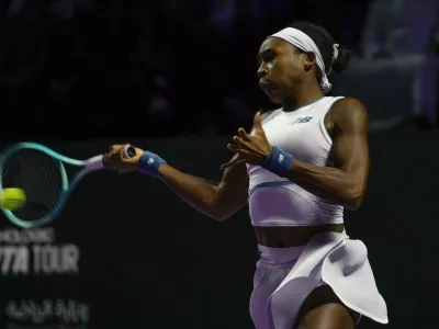 Coco Gauff of the United States plays a shot against Jasmine Paolini of Italy during their women's singles match at the WTA tennis finals in Riyadh, Saudi Arabia, Tuesday, Nov. 4, 2025. (AP Photo/ Fatima Shbair)