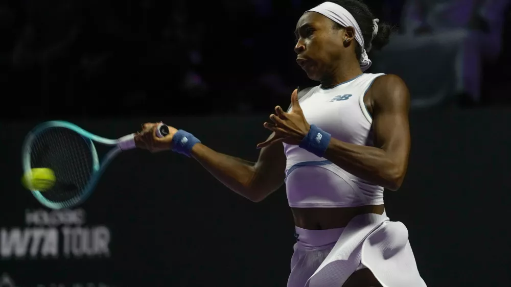 Coco Gauff of the United States plays a shot against Jasmine Paolini of Italy during their women's singles match at the WTA tennis finals in Riyadh, Saudi Arabia, Tuesday, Nov. 4, 2025. (AP Photo/ Fatima Shbair)