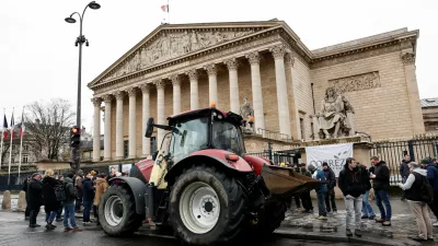 A tractor is parked in front of the National Assembly as French farmers protest against the government's handling of the EU-Mercosur free trade agreement and the handling of the lumpy skin disease outbreak, in Paris, France, January 8, 2026. REUTERS/Benoit Tessier