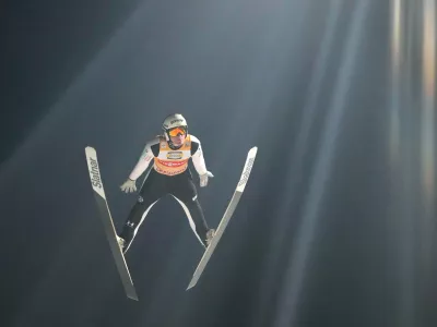 Domen Prevc, of Slovenia, soars through the air during his first round jump at the fourth stage of the Four Hills ski jumping tournament in Bischofshofen, Austria, Tuesday, Jan. 6, 2026. (AP Photo/Matthias Schrader)