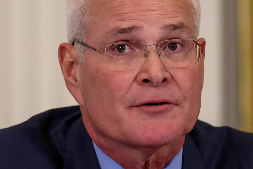 FILE PHOTO: ExxonMobil CEO Darren Woods looks on, during a U.S. President Donald Trump's meeting with an oil industry executives, at the White House in Washington, D.C., U.S., January 9, 2026. REUTERS/Kevin Lamarque/File Photo