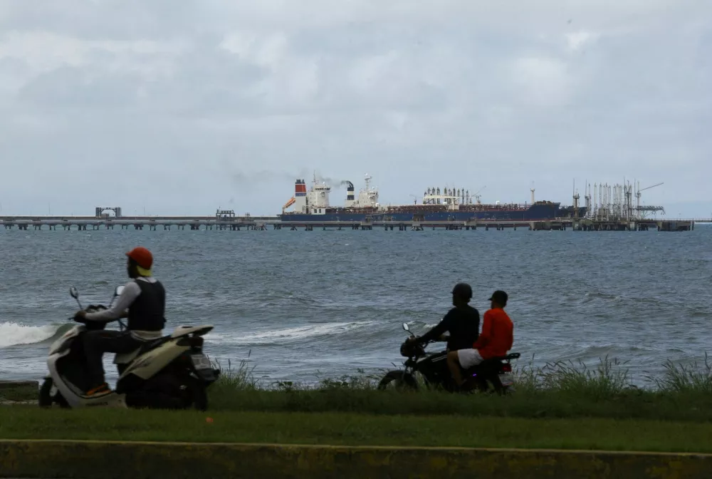FILE PHOTO: The Guinea-flagged oil tanker MT Bandra, which is under sanctions, is partially seen alongside another vessel at El Palito terminal, near Puerto Cabello, Venezuela December 29, 2025. REUTERS/Juan Carlos Hernandez/File Photo