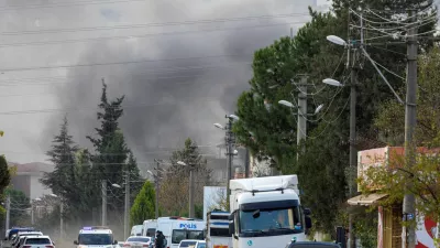 Smoke rises in the background as police block a road leading to a site where Turkish police launched an operation on a house believed to contain suspected Islamic State militants, and where, according to state media, seven officers were wounded in a clash, in Yalova province, Turkey, December 29, 2025. REUTERS/Umit Bektas   TPX IMAGES OF THE DAY