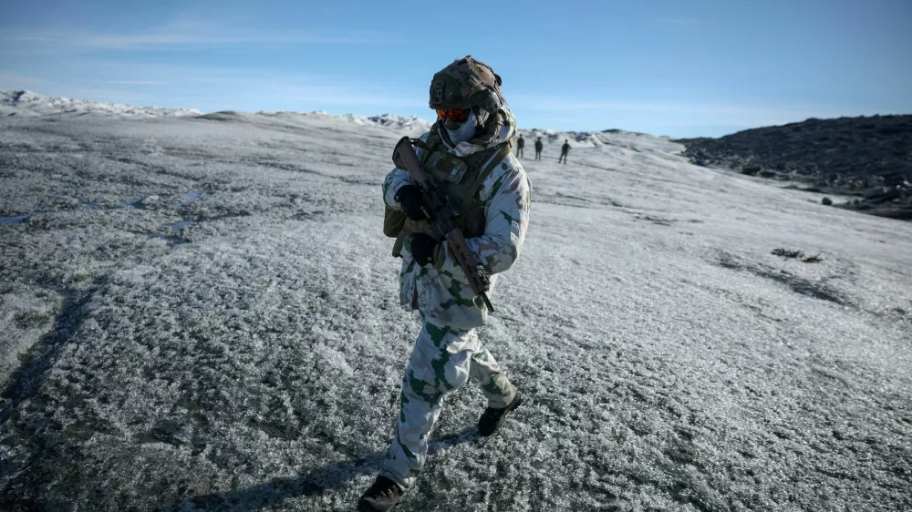 FILE PHOTO: A member of the French armed forces walks on ice during a military drill as Danish, Swedish and Norwegian home guard units together with Danish, German and French troops take part in joint military drills in Kangerlussuaq, Greenland, September 17, 2025. REUTERS/Guglielmo Mangiapane/File Photo