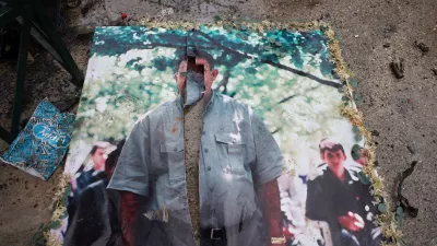 A defaced picture of Abdullah Ocalan, the imprisoned leader of the Kurdistan Workers' Party, or PKK, lies on the floor in the predominantly Kurdish Sheikh Maqsoud neighborhood in the northern city of Aleppo, Syria, Monday, Jan. 12, 2026, where clashes broke out on Jan. 6, between government forces and the Kurdish-led Syrian Democratic Forces. (AP Photo/Omar Albam)