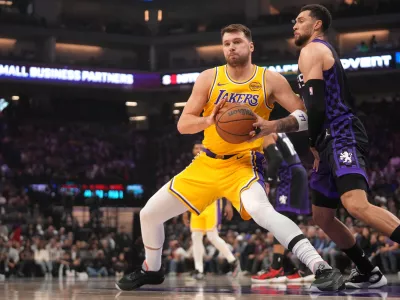 Jan 12, 2026; Sacramento, California, USA; Los Angeles Lakers guard Luka Doncic (77) battles for position with Sacramento Kings guard Zach LaVine (8) in the first quarter at the Golden 1 Center. Mandatory Credit: Cary Edmondson-Imagn Images