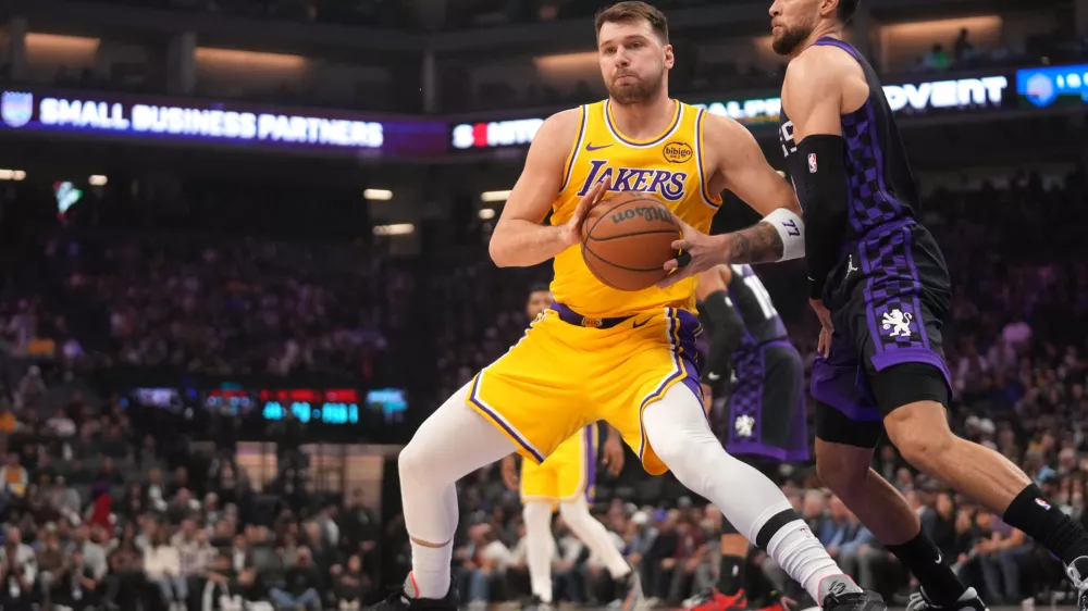 Jan 12, 2026; Sacramento, California, USA; Los Angeles Lakers guard Luka Doncic (77) battles for position with Sacramento Kings guard Zach LaVine (8) in the first quarter at the Golden 1 Center. Mandatory Credit: Cary Edmondson-Imagn Images
