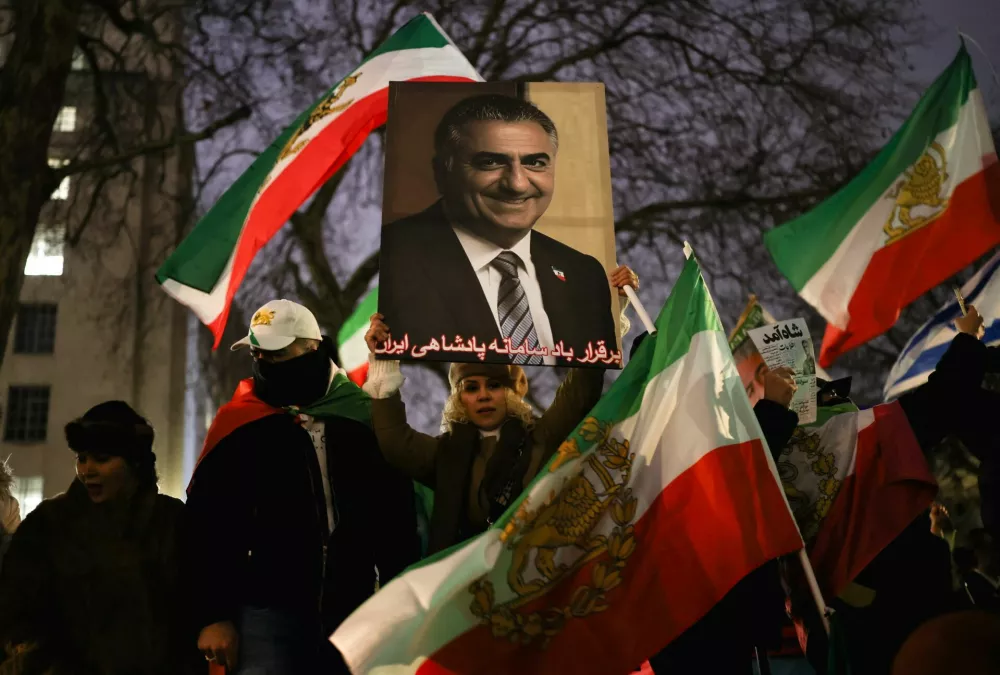 A woman holds up an image of Reza Pahlavi, the exiled son of the last Shah of Iran, as Stop the Hate UK holds a protest calling on British Prime Minister Keir Starmer to support the Iranian people, proscribe the Islamic Revolutionary Guard Corps (IRGC) and free Iran from the Islamic Republic, outside Downing Street, London, Britain, January 11, 2026. REUTERS/Isabel Infantes