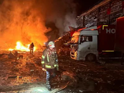 Firefighters work at the site of a logistics hub of a private delivery company hit by Russian missile strikes, amid Russia's attack on Ukraine, in Kharkiv, Ukraine January 13, 2026. REUTERS/Vitalii Hnidyi