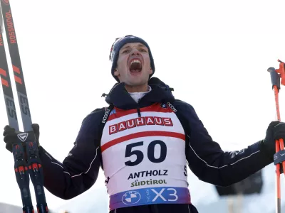 Third placed Tommaso Giacomel of Italy celebrates after a Biathlon men's World Cup 10km sprint race, in Anterselva, Italy, Friday Jan. 24, 2025. (AP Photo/Alessandro Trovati)