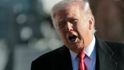 U.S. President Donald Trump speaks to reporters, on his way to the Marine One helicopter to depart the White House for travel to Detroit, Michigan, in Washington, D.C. U.S. January 13, 2026. REUTERS/Jonathan Ernst