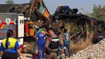 This photo released from State Railway of Thailand, shows aid workers after a construction crane fell into a passenger train in Nakhon Ratchasima province, Thailand Wednesday, Jan. 14, 2026. (State Railway of Thailand via AP)
