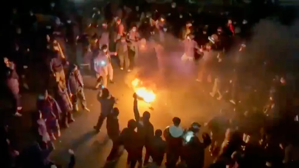 FILE - This frame grab from footage circulating on social media shows protesters dancing and cheering around a bonfire as they take to the streets despite an intensifying crackdown as the Islamic Republic remains cut off from the rest of the world, in Tehran, Iran, Jan. 9, 2026. (UGC via AP, File)