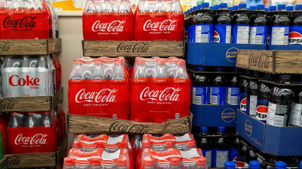 FILE PHOTO: Cases of soft drinks, including Coca-Cola and Pepsi, are stacked for sale at a grocery store in Hamilton, Ontario, Canada, January 28, 2025. REUTERS/Carlos Osorio/File Photo