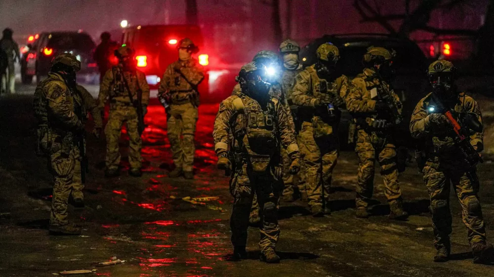 Members of law enforcement gather, as tensions rise after federal law enforcement agents were involved in a shooting incident, a week after a U.S. Immigration and Customs Enforcement (ICE) agent fatally shot Renee Nicole Good, in north Minneapolis, Minnesota, U.S., January 14, 2026. REUTERS/Ryan Murphy